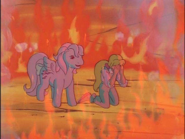 A screenshot from the cartoon series Pony Tales, featuring Megan Williams and Wind Whistler surrounded by a ring of fire.